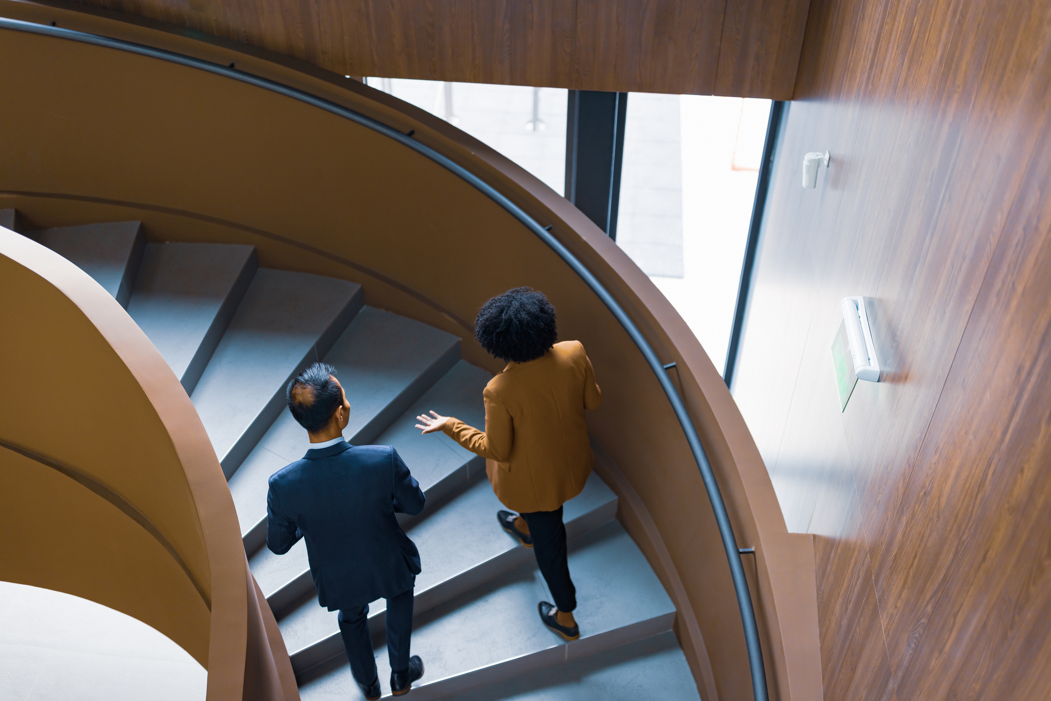 Business Colleagues Discussing on Spiral Staircase